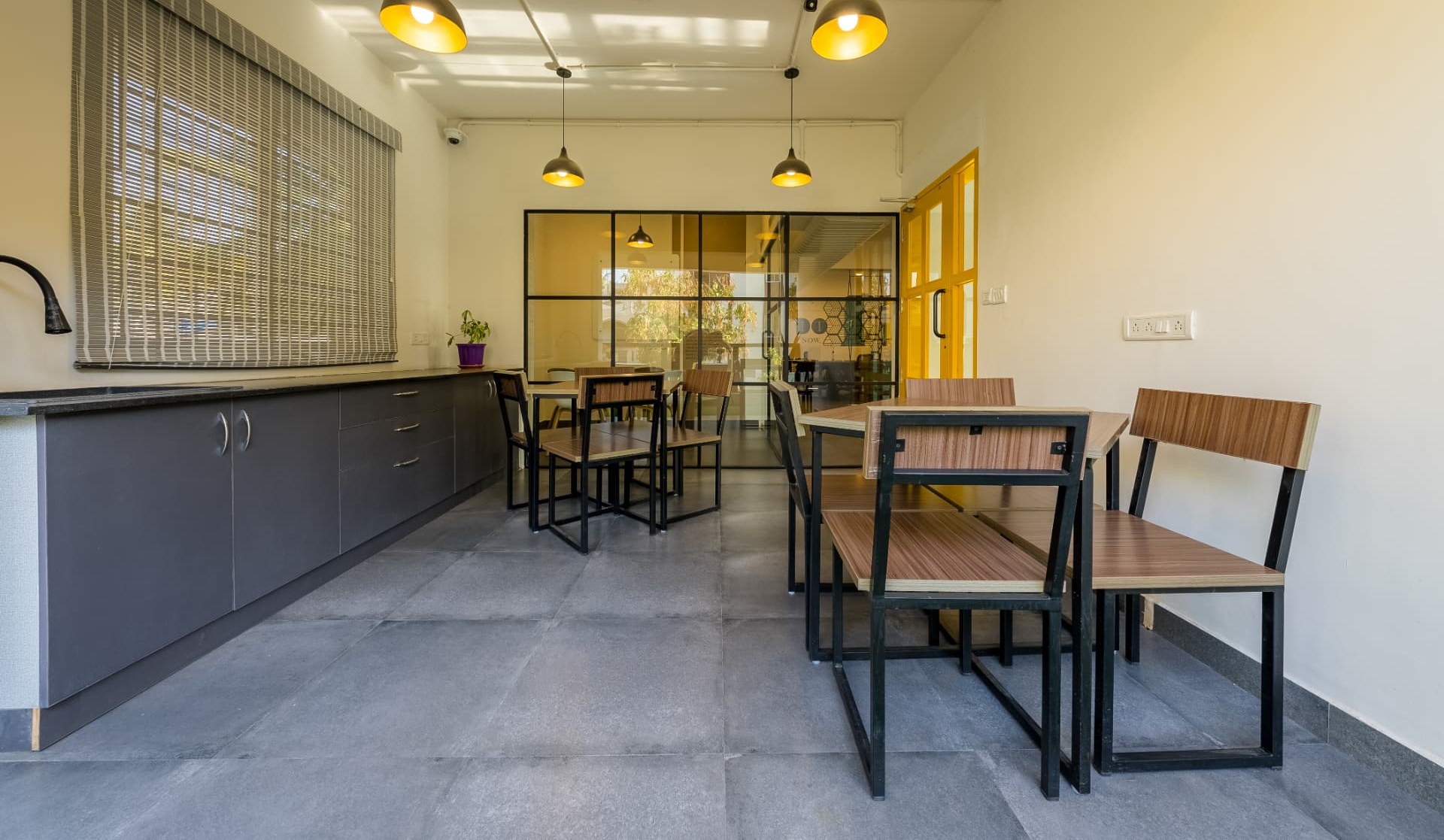 Pantry and balcony seating with pendant lighting and timber tables