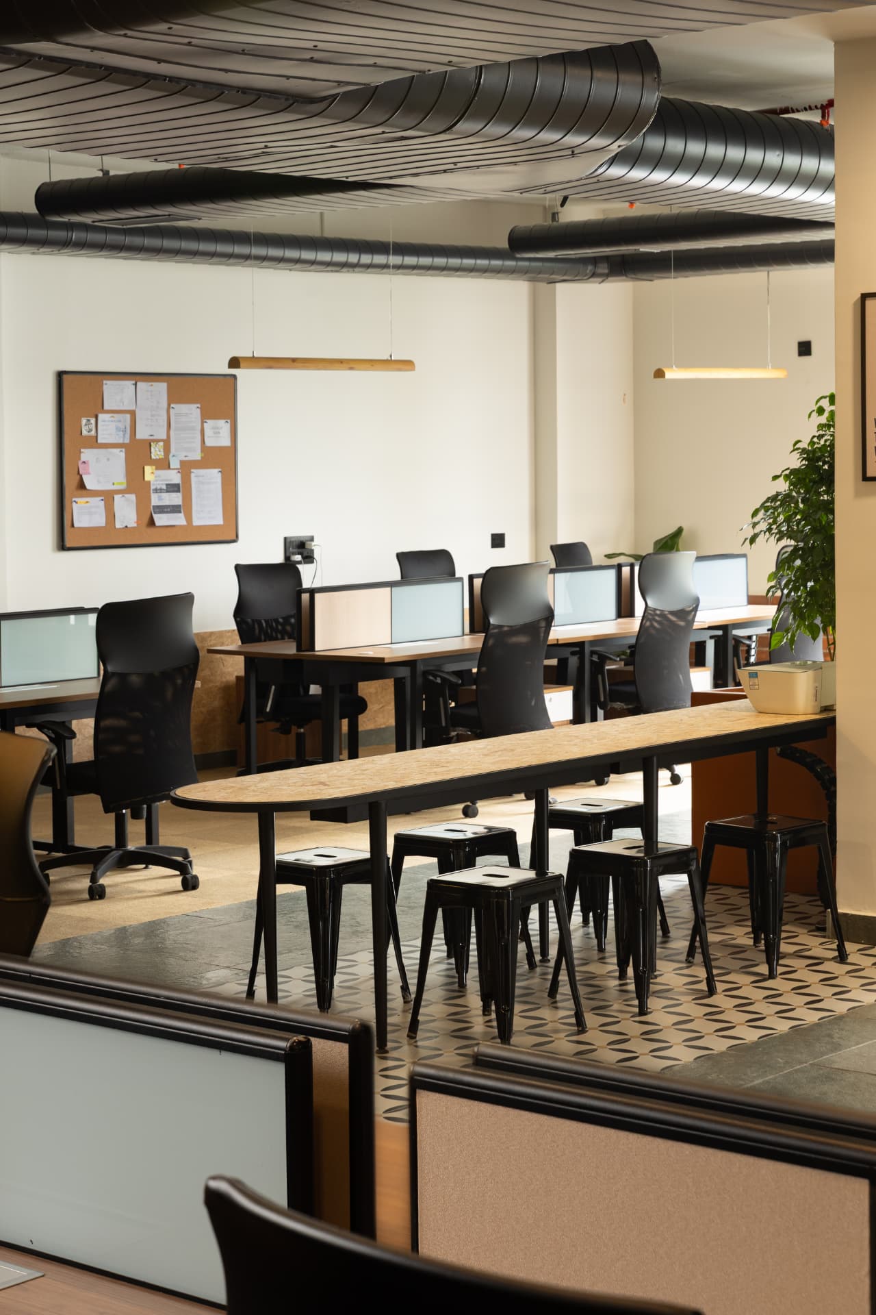Workstation bays and a long high table with stools at Steadwork ORR | Panathur