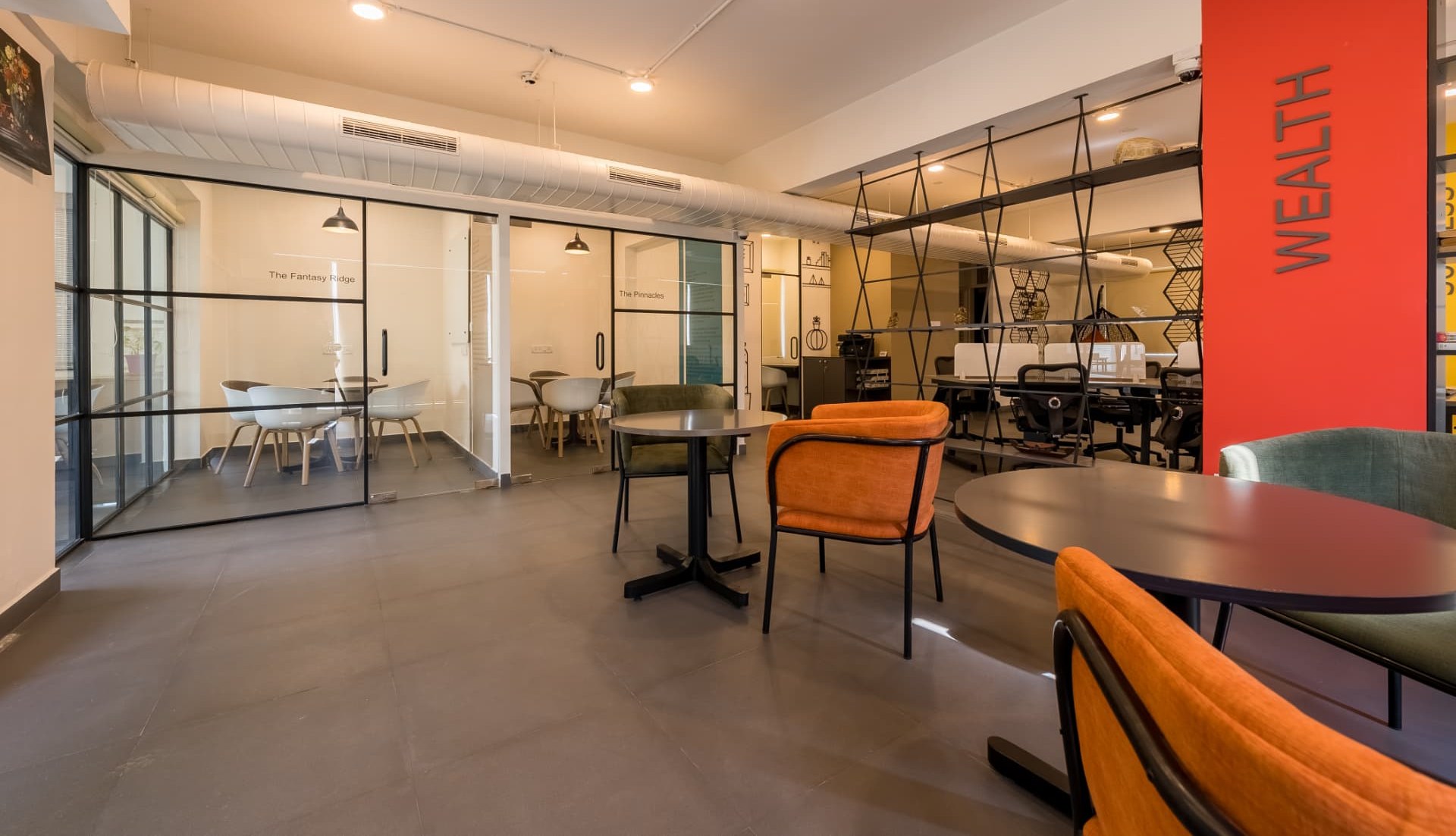 Breakout seating outside two glazed meeting rooms at Steadwork