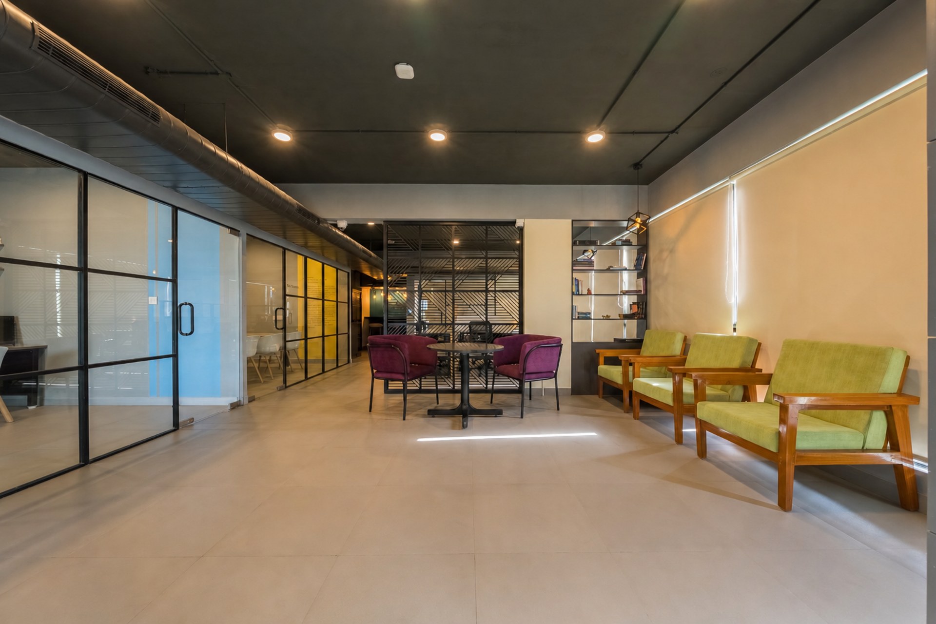 Third floor corridor lounge with timber seating and glass-fronted cabins